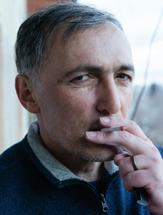 a man with a cigarette in his mouth, inspired by Karl Matzek, trending on pexels, fluxus, 50 years old, lgbtq, pensive expression, vitaly bugarov