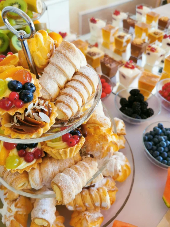 a table topped with lots of different types of food, cream, fruit, profile image, up-close