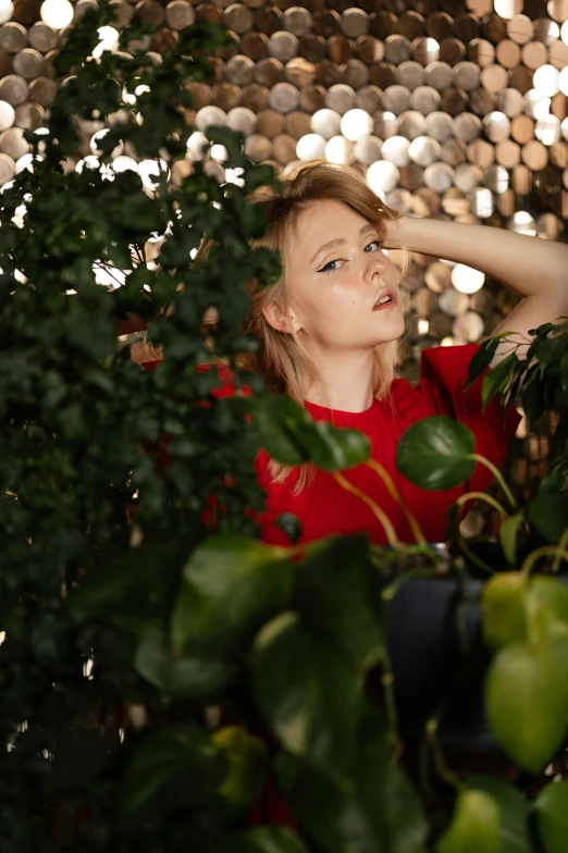 a woman sitting on top of a lush green tree, an album cover, by Julia Pishtar, unsplash, realism, red door blonde, next to some alien plants, close - up studio photo, woman made of plants