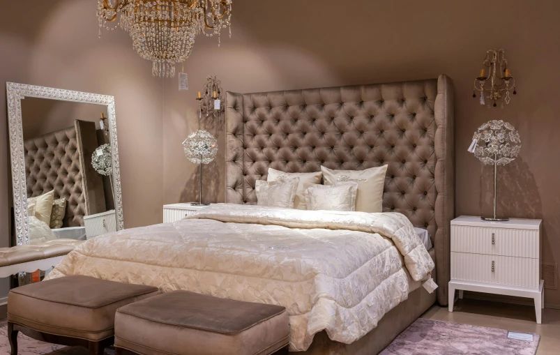 a bed room with a neatly made bed and a chandelier, inspired by Albert Paris Gütersloh, pinterest, baroque, taupe, ameera al taweel, modern gallery furniture, with sparkling gems on top