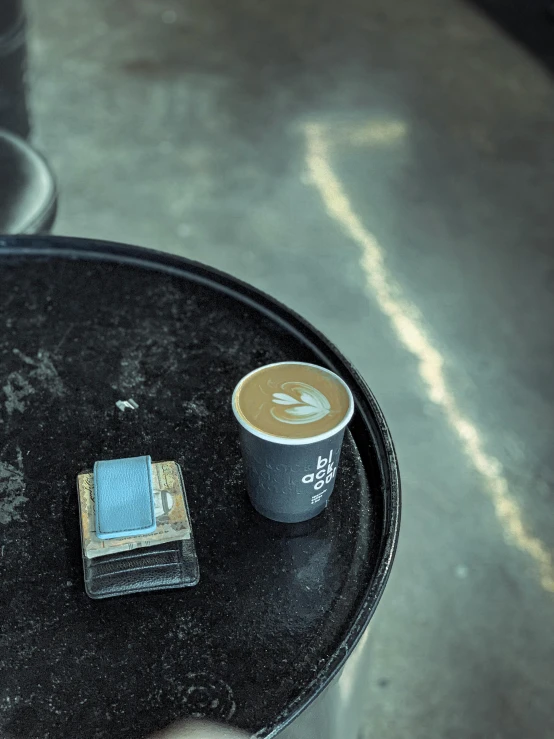 a person holding a cell phone next to a cup of coffee, a still life, by Daniel Gelon, unsplash contest winner, dau-al-set, instagram story, blue and grey, street life, high angle close up shot