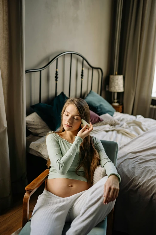 a pregnant woman sitting in a chair in a bedroom, inspired by Elsa Bleda, trending on pexels, renaissance, sleepy expression, ( 3 1, soft green natural light, instagram post