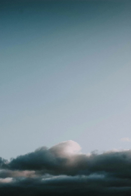 a large jetliner flying through a cloudy sky, a picture, unsplash, minimalism, 4 k film still, morning sunlight, face made out of clouds, # film