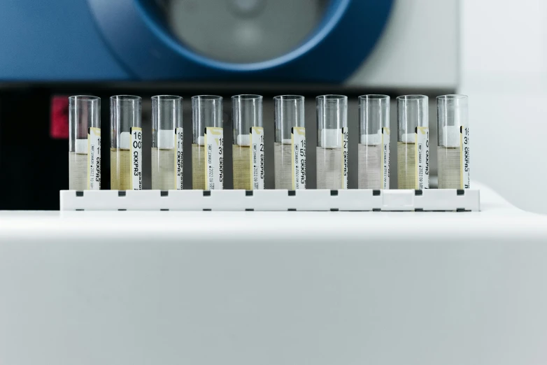 a row of test tubes sitting on top of a counter, a microscopic photo, unsplash, analytical art, medical machinery, panels, 4 0 0 0 samples, fan favorite