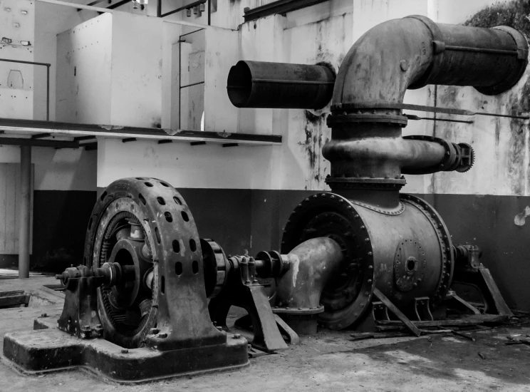 a black and white photo of a machine, a black and white photo, by John Murdoch, pexels contest winner, renaissance, purpose is pump, black and white and red colors, realistic old photo, jet turbine