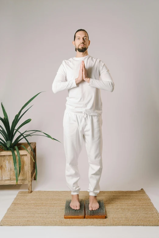 a man standing on a scale with his hands in the air, by Nina Hamnett, white outfit, zen meditation, tracksuit, thumbnail