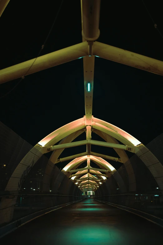 a view of the inside of a tunnel at night, unsplash, modernism, peaked wooden roofs, 1990s photograph, on a bridge, symmetrical complex fine detail