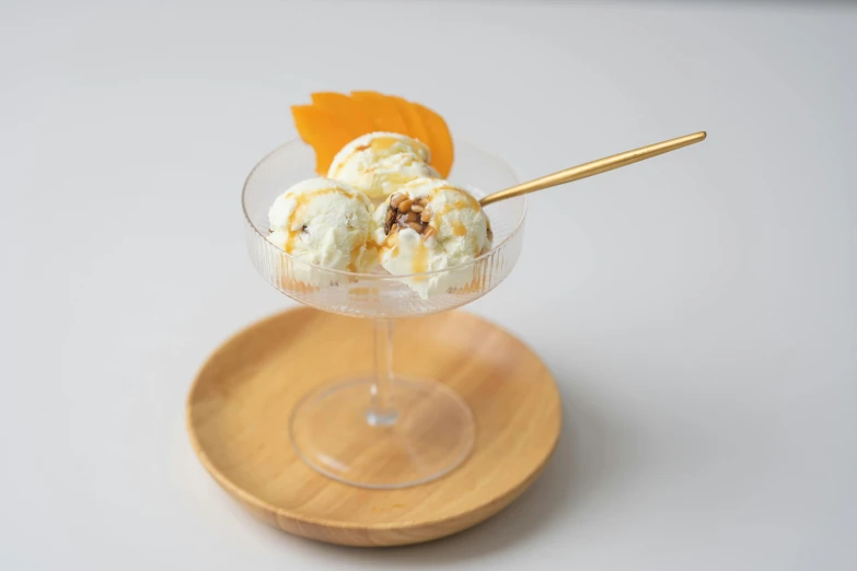 a glass of ice cream sitting on top of a wooden plate, honey wind, product display photograph, male!!, aphrodite
