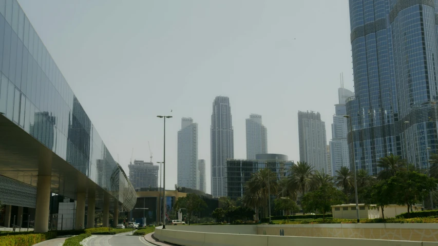 a city street filled with lots of tall buildings, inspired by Zaha Hadid, hurufiyya, dubai, low quality photo, majestic spires, museum photo