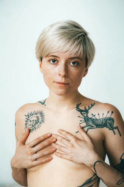 a woman with a tattoo on her chest, by Jessie Alexandra Dick, pexels contest winner, renaissance, set against a white background, beth cavener, sarah andersen, short antlers