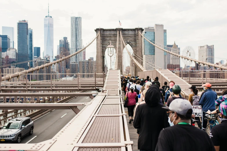 a group of people walking across a bridge, watching new york, people are wearing masks, unsplash photography, frank gehry