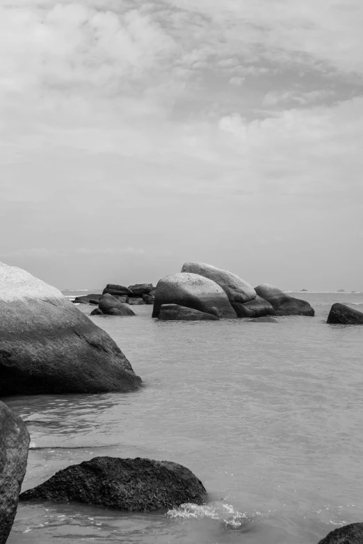 a black and white photo of rocks in the water, sri lanka, ((rocks))