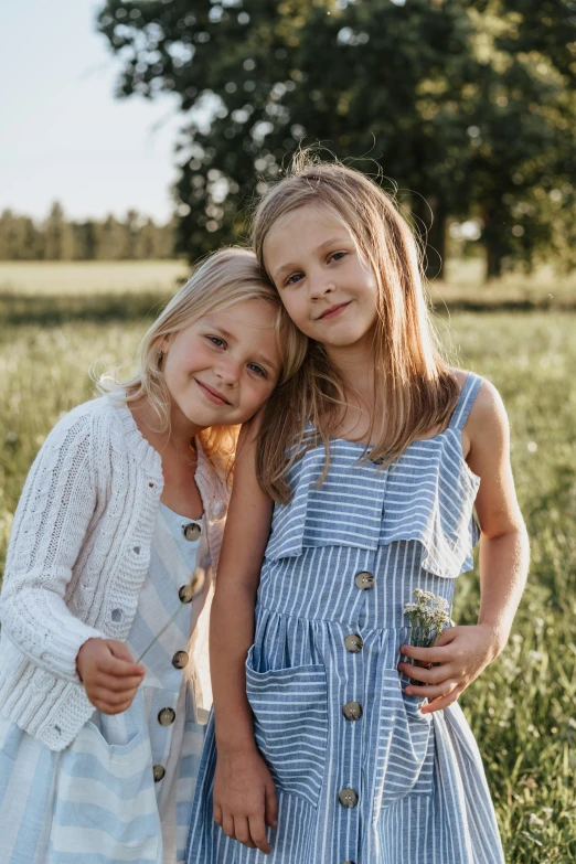 two little girls standing next to each other in a field, by Anato Finnstark, unsplash, portrait image, blond, ready to model, 15081959 21121991 01012000 4k