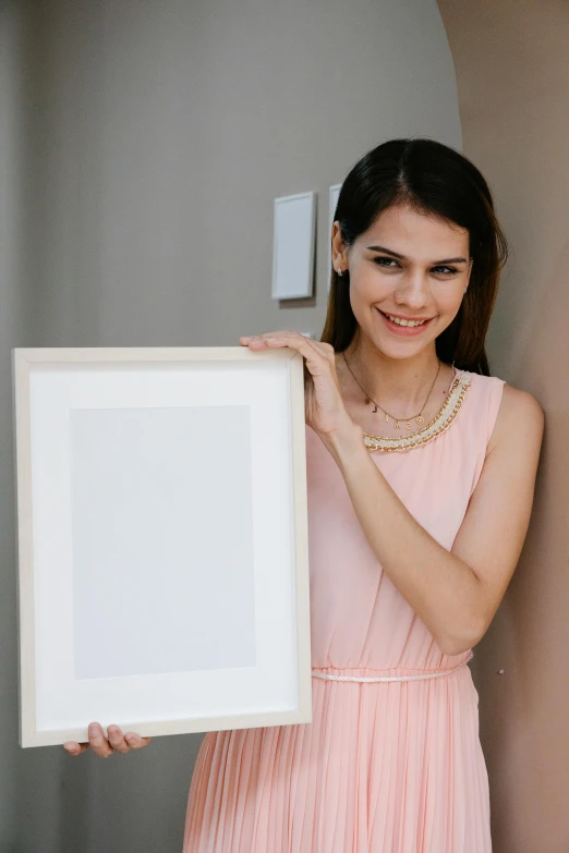 a woman in a pink dress holding a picture frame, a picture, pexels contest winner, brunette woman, white frame, 15081959 21121991 01012000 4k, square pictureframes