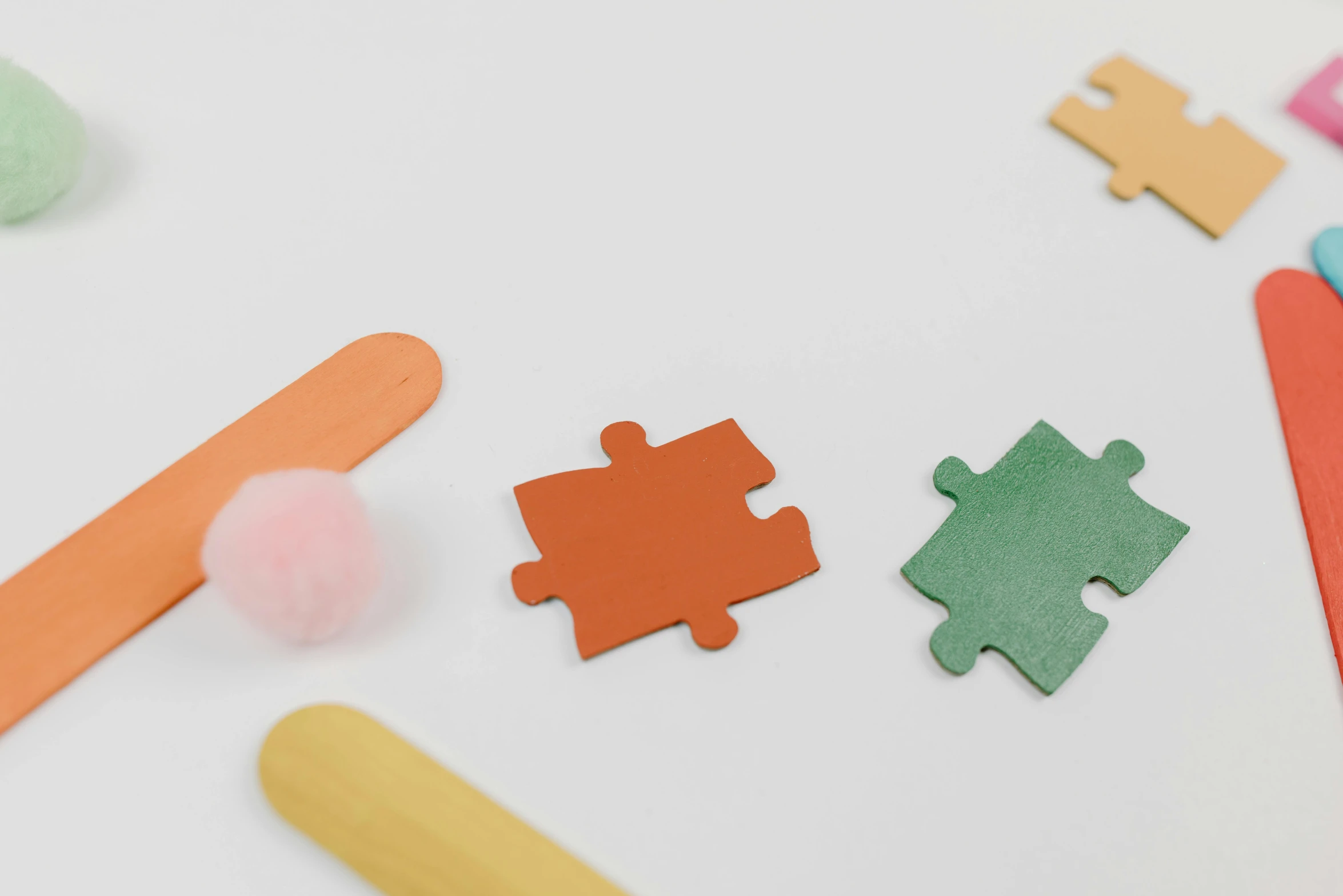 a close up of a puzzle piece on a table, inspired by Frederick Hammersley, color field, orange pastel colors, stickers, asset on grey background, plush leather pads