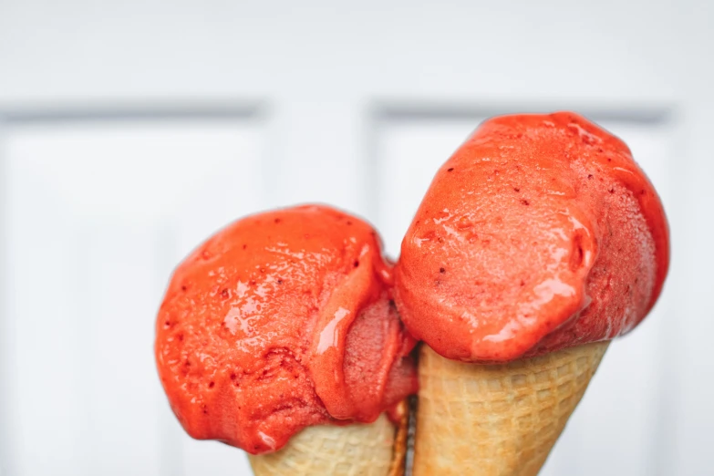 two scoops of ice cream in a waffle cone, pexels contest winner, coral red, monochromatic red, trinidad scorpion, 🦩🪐🐞👩🏻🦳