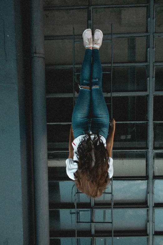 a person hanging upside down in a building, inspired by Elsa Bleda, pexels contest winner, happening, girl with brown hair, wearing jeans, photo of a black woman, looking like a bird