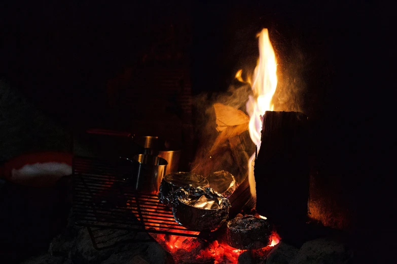 a close up of a fire in a fireplace, barrel fires and tents, ready to eat, instagram post, foil