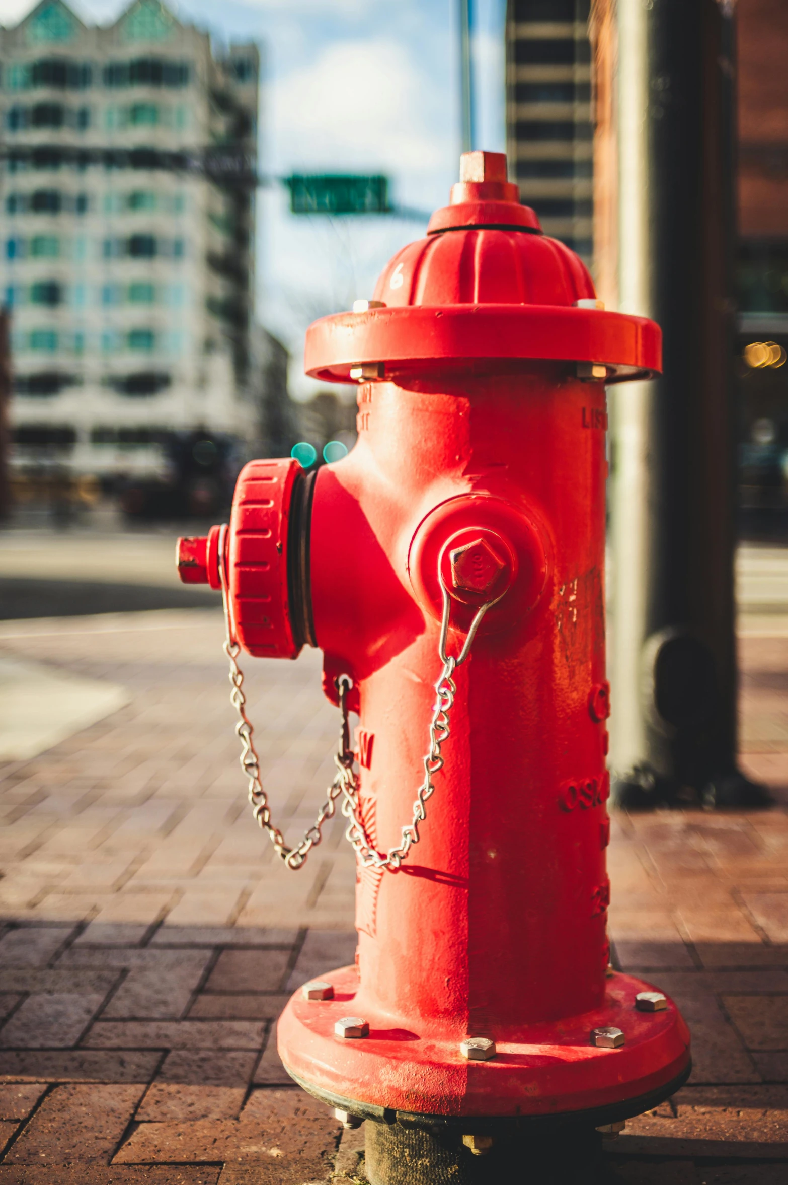 a red fire hydrant sitting on the side of a road, a colorized photo, pexels contest winner, street art, square, water fountain, chain, brightly lit