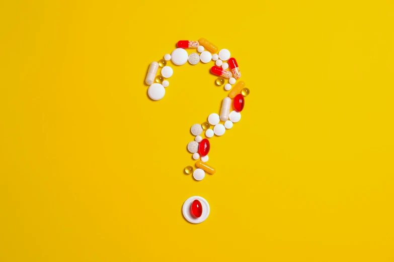 a question mark made out of pills on a yellow background, an illustration of, by Julia Pishtar, shutterstock, antipodeans, made out of sweets, 💋 💄 👠 👗, commercial photo, mystery code