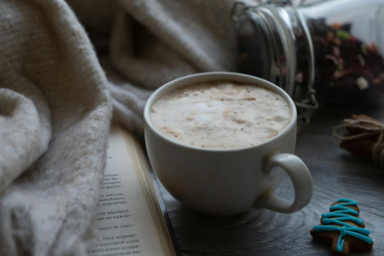 a book sitting on top of a table next to a cup of coffee, with a cup of hot chocolate, thumbnail, recipe, portrait shot