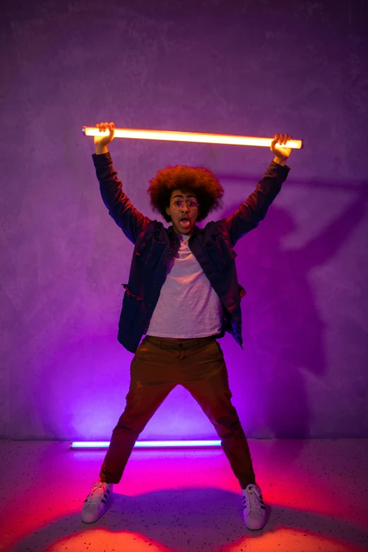 a man holding a light saber over his head, pexels, light and space, curly afro, teenage boy, orange and purple electricity, full body hero