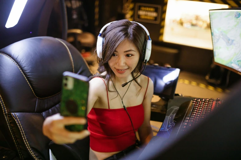 a woman wearing headphones sitting in front of a computer, inspired by Lan Ying, featured on reddit, hurufiyya, mobile game, taking a selfie, server in the middle, gtr xu1