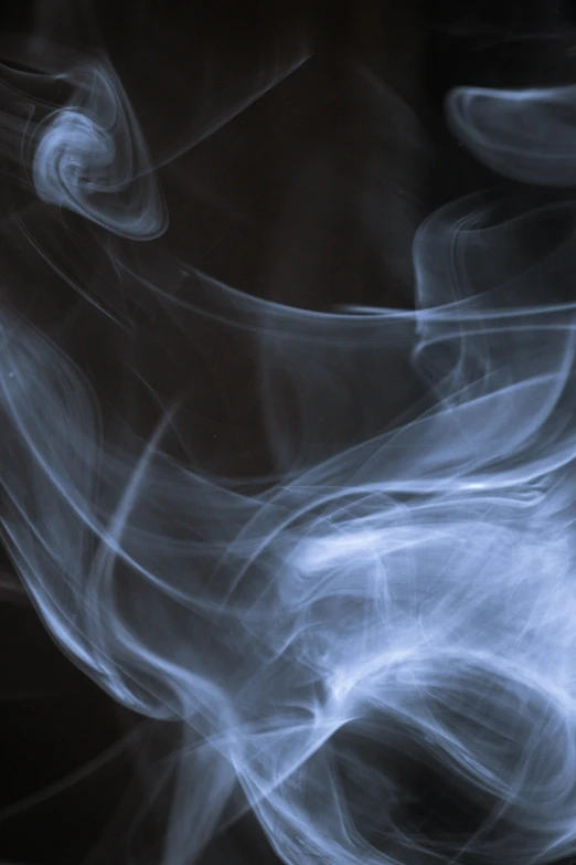 a close up of smoke on a black background, by David Donaldson, unsplash, light blue mist, spiraling, praying with tobacco, hazy