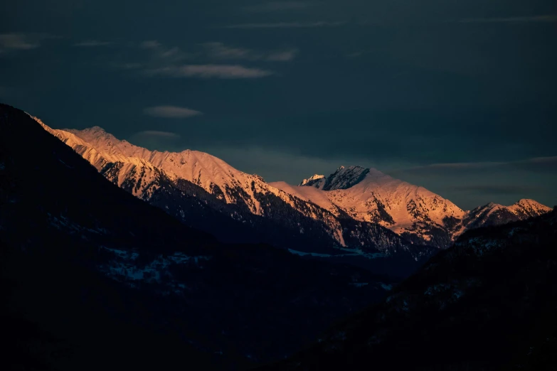 a mountain range with snow covered mountains in the background, inspired by Elsa Bleda, pexels contest winner, baroque, evening lighting, brown, front lit, instagram post