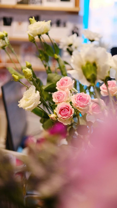 a vase filled with pink and white flowers, by Julian Allen, unsplash, flower shop scene, detail shot, busy, wide screenshot