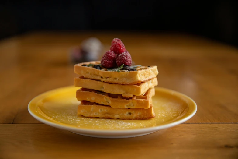 a stack of waffles with raspberries on top, a portrait, unsplash, medium format, yellow, artoast8p, drink