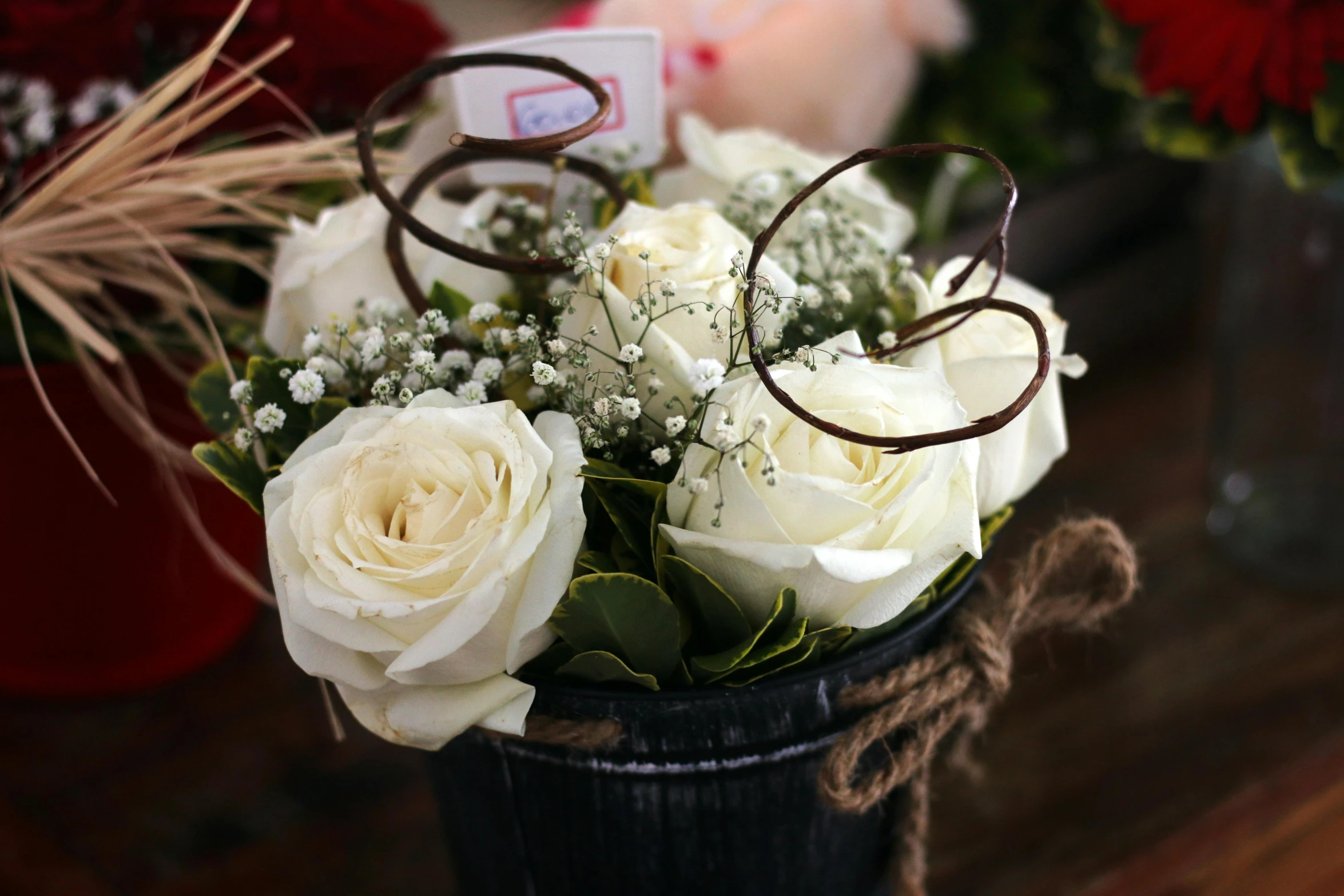 a vase filled with white roses and baby's breath, pexels, romanticism, white spiral horns, brown, flower shop scene, low detail