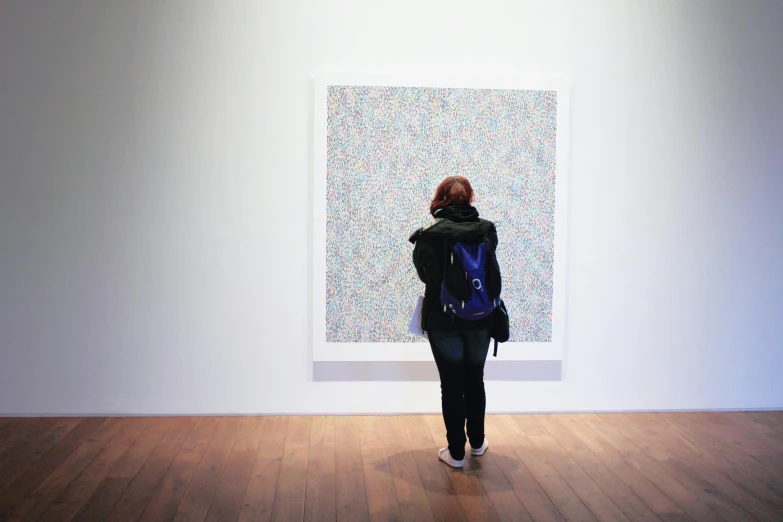 a woman standing in front of a painting on a wall, a pointillism painting, by Damien Hirst, pexels, walking away from the camera, 144x144 canvas, white wall, academic painting