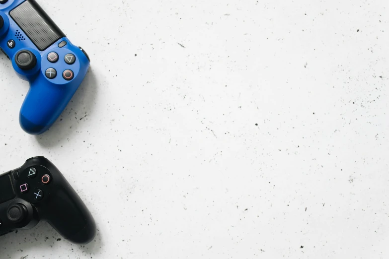 a couple of video game controllers sitting next to each other, a picture, pexels, minimalism, white and blue, instagram post, blue and black, action photograph