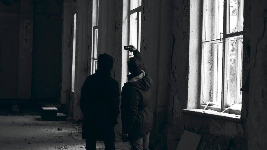 a couple of people standing in front of a window, inspired by Elsa Bleda, pexels contest winner, urbex, found footage video, inspect in inventory image, long shot from back