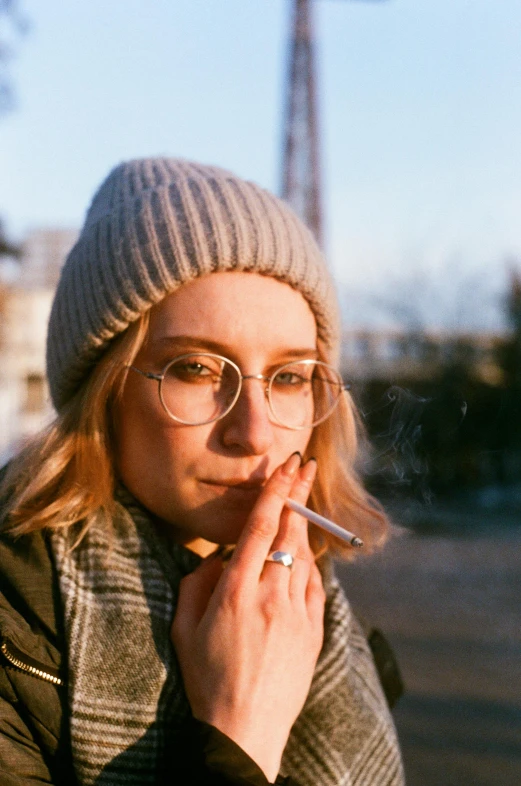 a woman with glasses smoking a cigarette, inspired by Elsa Bleda, trending on pexels, wearing beanie, sydney sweeney, lo fi, portrait pose