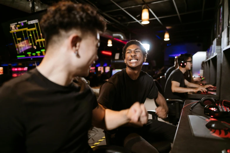 a group of young men playing a video game, pexels contest winner, happening, dim dingy gym, lee madgwick & liam wong, smiling at each other, black