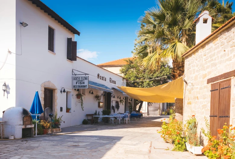 a street with tables and umbrellas in front of a building, mediterranean fisher village, akitipe studios, perfect crisp sunlight, thumbnail