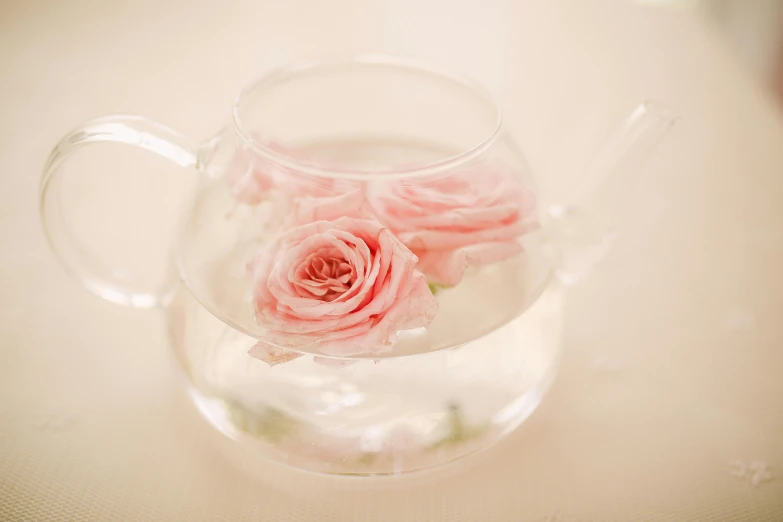 a vase filled with pink roses sitting on top of a table, filled with water, jen atkin, pot, soft focus