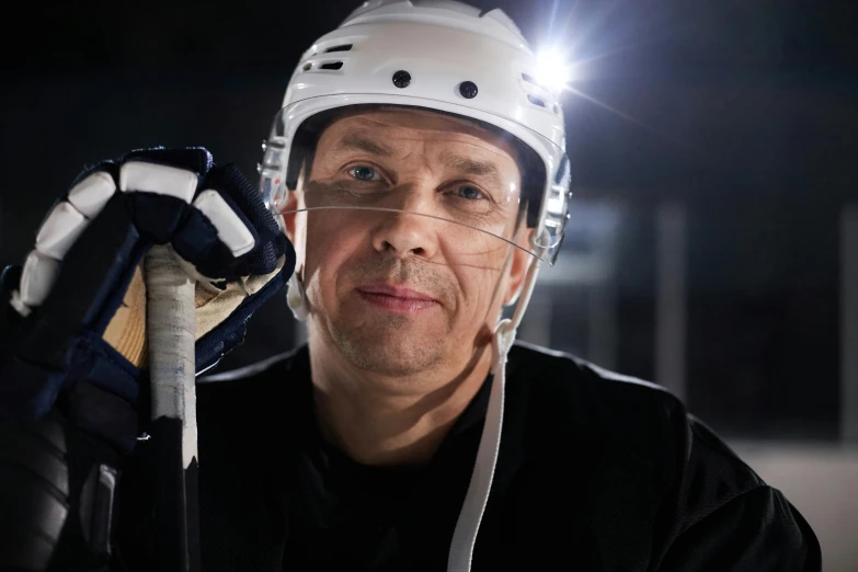 a man wearing a helmet and holding a hockey stick, a portrait, pexels contest winner, front flash, no - text no - logo, enlightening, jeff lyons