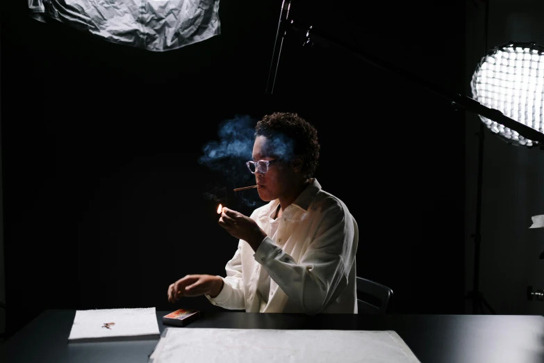 a woman sitting at a desk smoking a cigarette, inspired by Carrie Mae Weems, pexels contest winner, wearing lab coat and glasses, making of, experimental studio light, animation