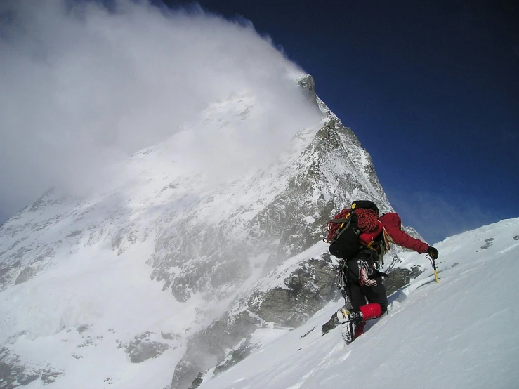 a man riding skis down the side of a snow covered mountain, pexels contest winner, nepal, national geograph, climbing, towering