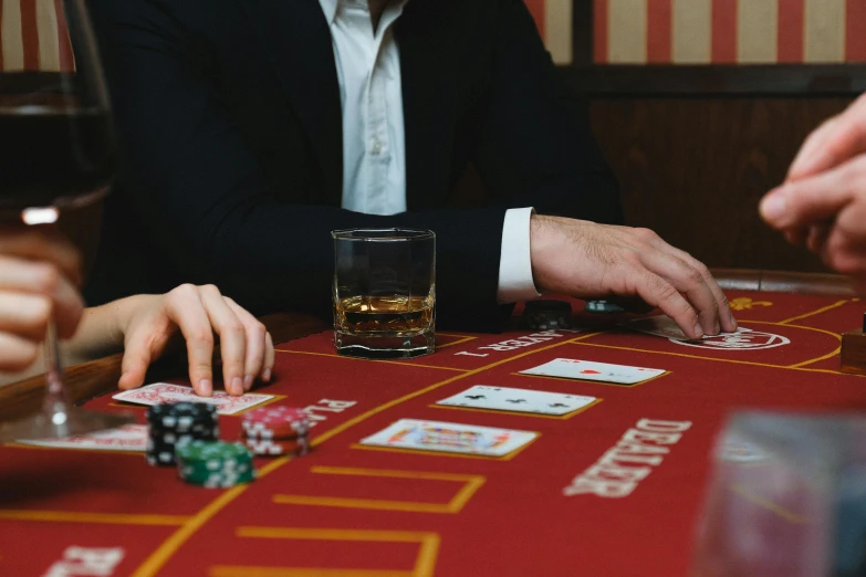 a group of people playing cards at a casino table, a screenshot, pexels contest winner, whisky, game cover, understated, rectangle