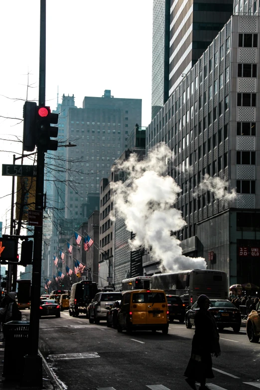 a street filled with lots of traffic next to tall buildings, by Greg Rutkowski, excessivism, exhaust smoke, new - york skyline in winter, hot day, boiling