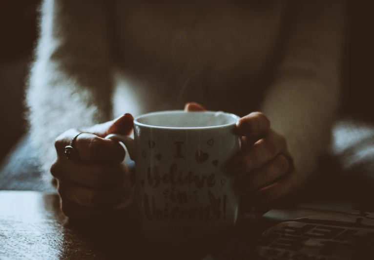 a close up of a person holding a coffee cup, inspired by Elsa Bleda, trending on pexels, romanticism, vintage photo, background image