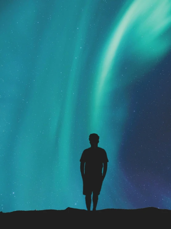 a man standing on top of a hill under the aurora lights, poster art, pexels contest winner, profile image, teal aesthetic, no - text no - logo, photo on iphone