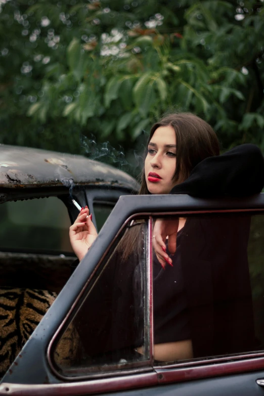 a woman sitting in a car smoking a cigarette, an album cover, inspired by Elsa Bleda, trending on pexels, visual art, anna nikonova, square, high quality photo, warpaint aesthetic