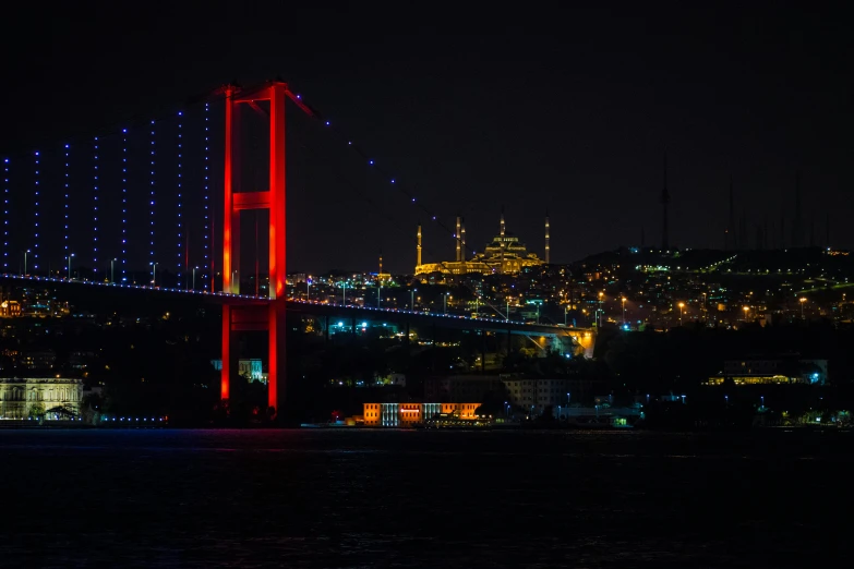 a large bridge over a body of water at night, by Ismail Acar, pexels contest winner, hurufiyya, red castle in background, 2 5 6 x 2 5 6, turkish and russian, a colorful