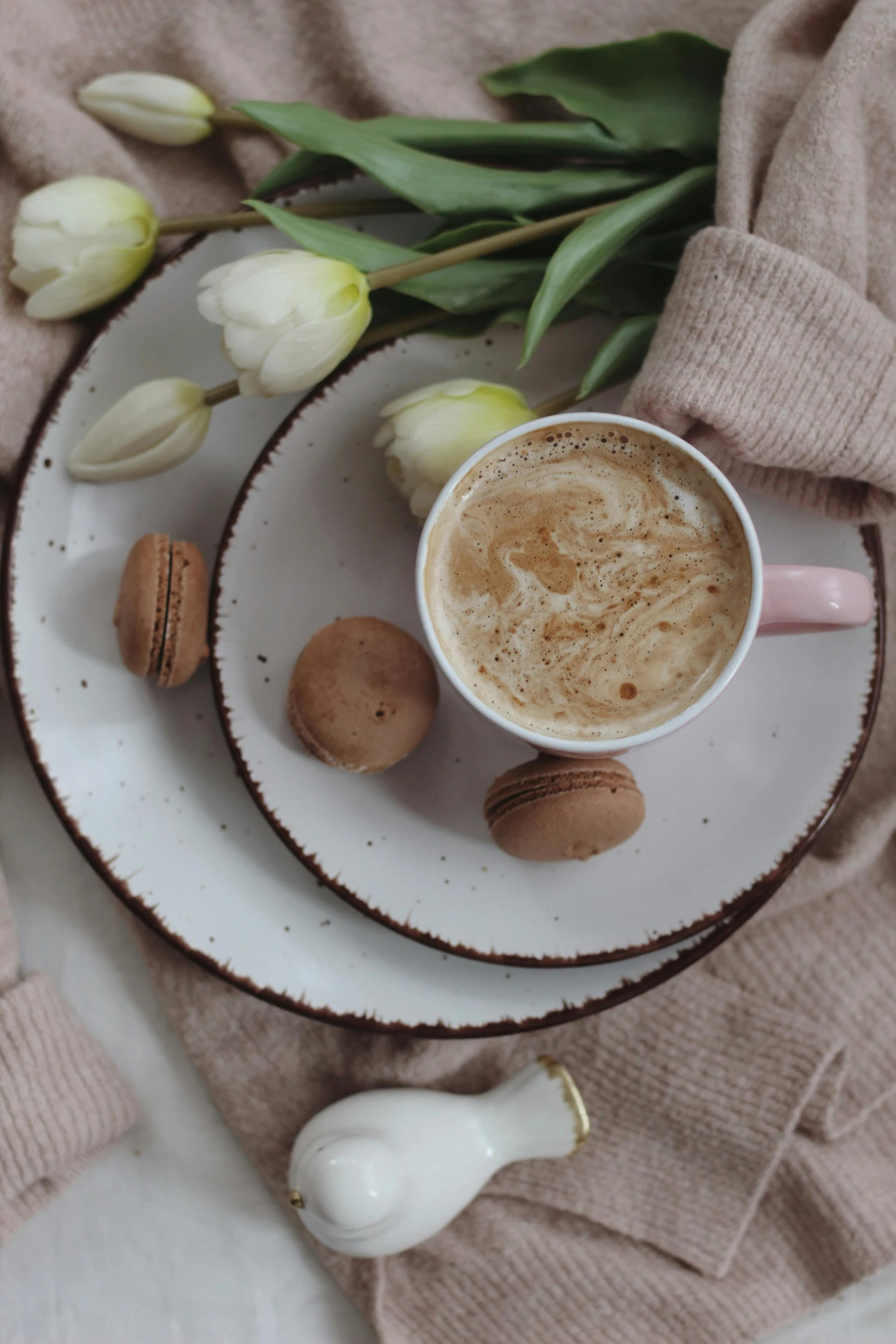 a cup of coffee sitting on top of a white plate, macaron, brown and pink color scheme, tulip, high quality product image”