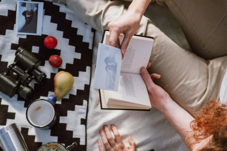 a woman sitting on a blanket reading a book, pexels contest winner, people on a picnic, dixit card, interior shot, subtle detailing